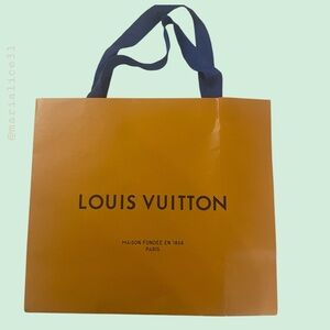 Louis Vuitton Traditional Orange Shopping Bag with cobalt blue handles.